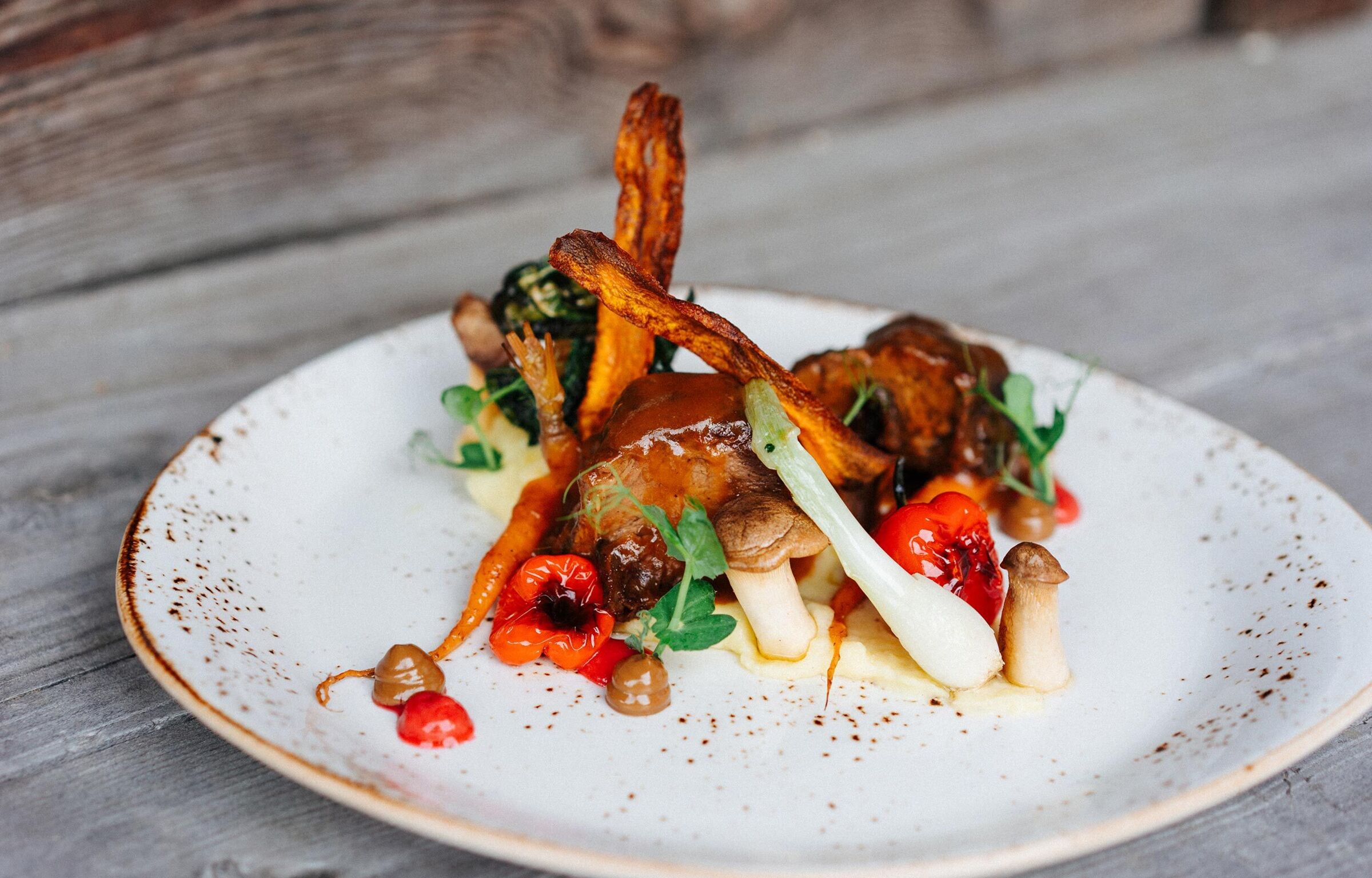 Sweet potato fries with meat and mushrooms were draped on a plate