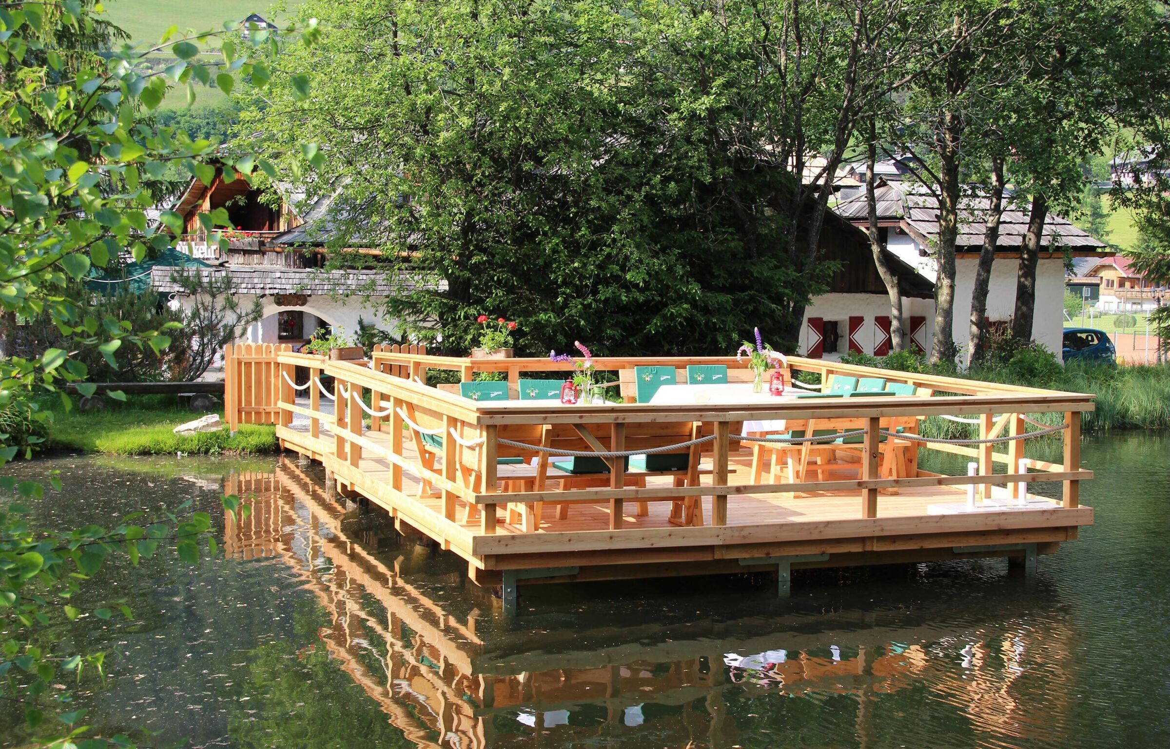 A wooden jetty in the lake with tables and chairs